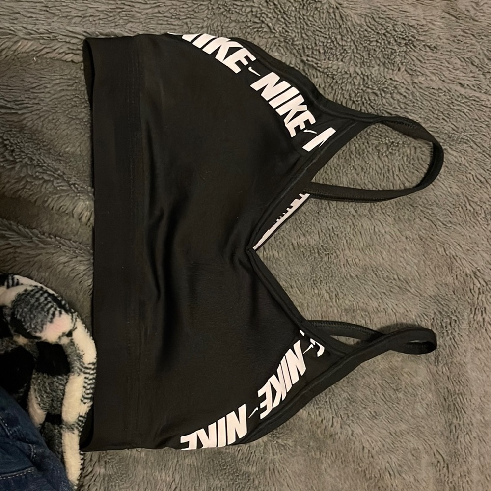 black nike sports bra with white lettering.